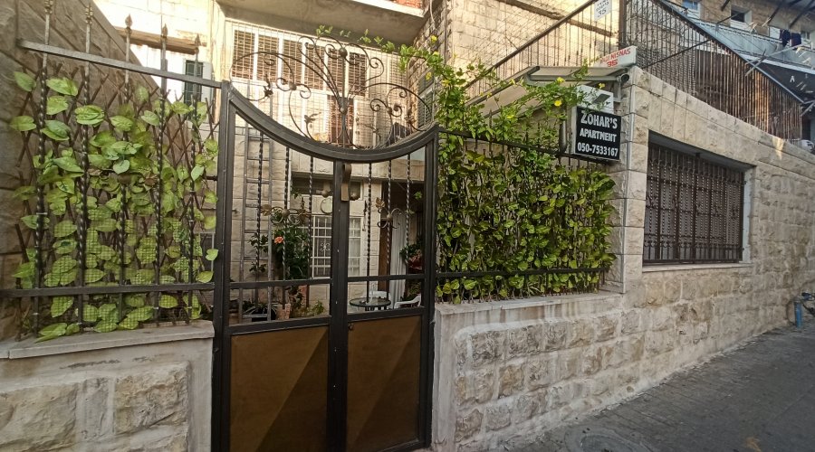 Stone facade and iron gate of Zohar's Apartment